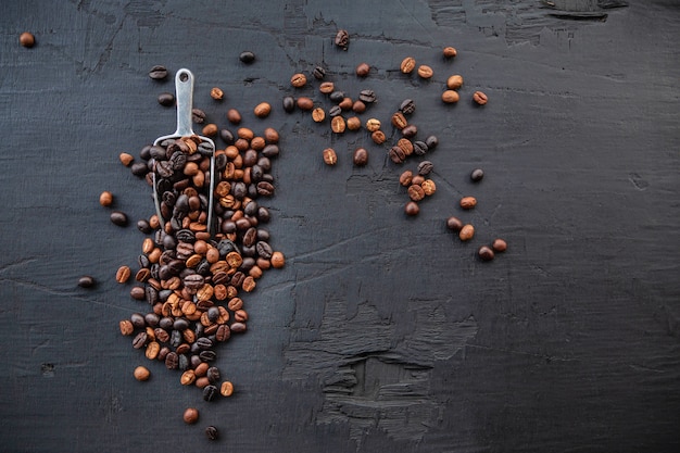 Coffee beans roasted on a black wooden background