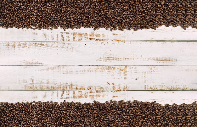 Coffee beans on rustic wood background