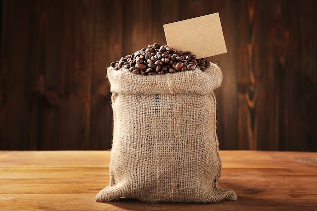 Coffee beans in sackcloth on table