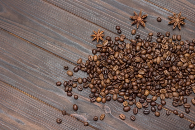 Coffee beans scattered on table and star anise