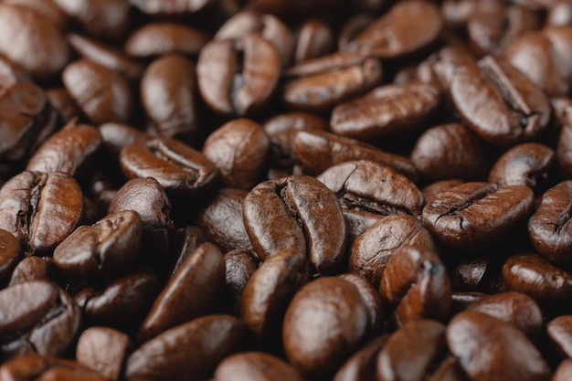 Coffee beans texture. Close up roasted arabaca background. Side view.