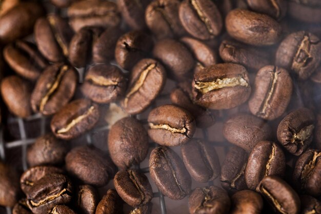 Coffee beans texture or coffee background. Fragrant fried bean  a-smoke.