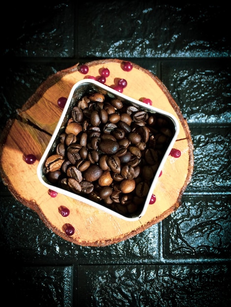 Coffee beans in a tin on a dark background