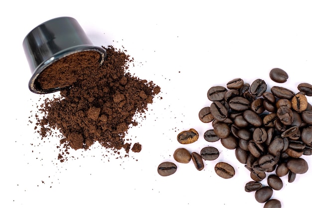 coffee beans vs ground coffee or in capsules,pods.roasted brown coffee beans in plastic opened pod.