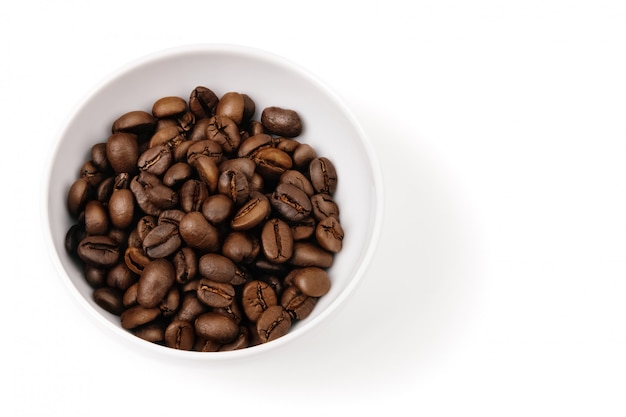 Coffee beans in a white cup. Isolated.