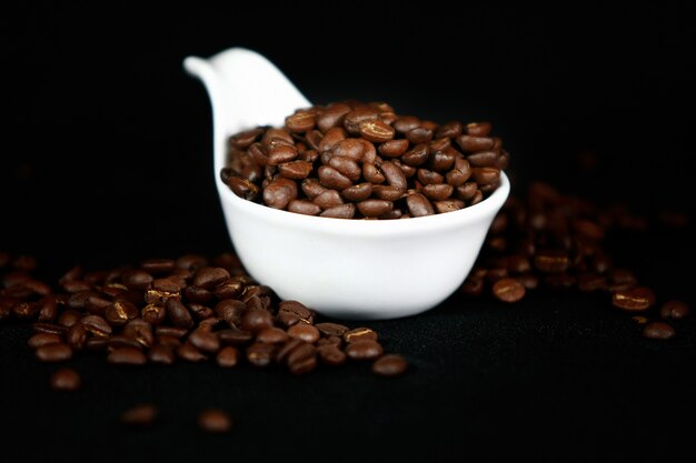 Coffee beans in a white cup