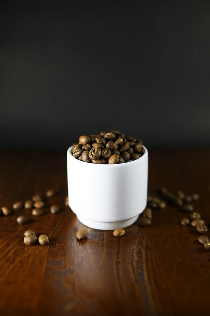 Coffee beans on white glass table top style food.