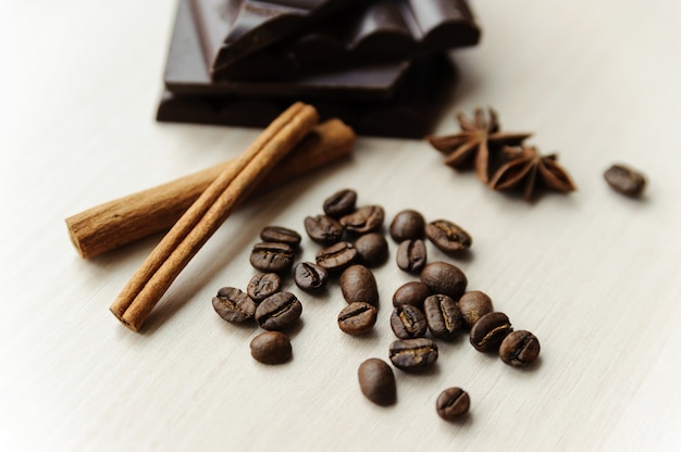 Coffee beans with cinnamon sticks and chocolate