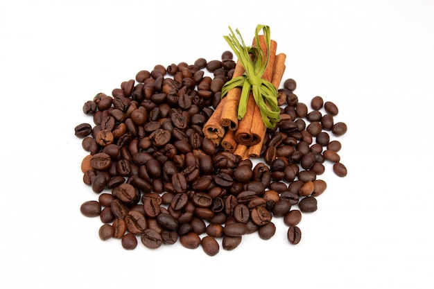 Coffee beans with cinnamon sticks on a white space