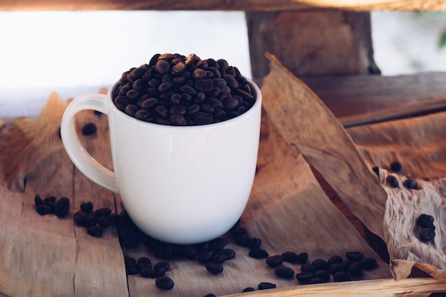 Coffee beans with a cup on the table