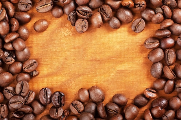 Coffee Beans over Wood Background