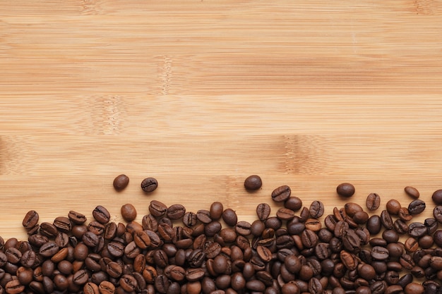 Coffee beans on wooden background from above with copyspace