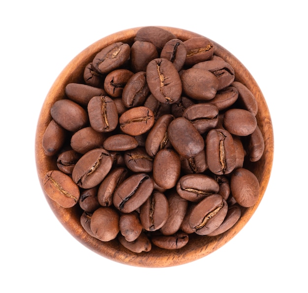 Coffee beans in wooden bowl isolated on white background. Roasted arabica coffee beans. Top view.