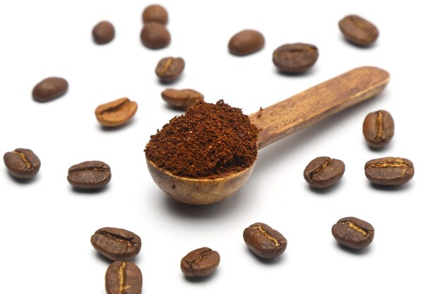 Coffee beans in a wooden scoop isolated on a white background Roasted coffee beans isolated