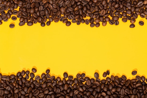 Coffee beans on yellow surface