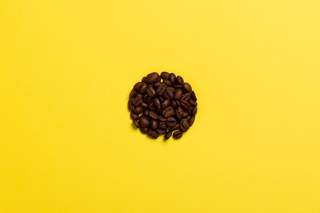 Coffee beans on a yellow surface