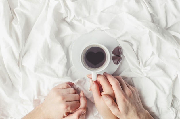 Coffee in bed. Selective focus. Love drink.