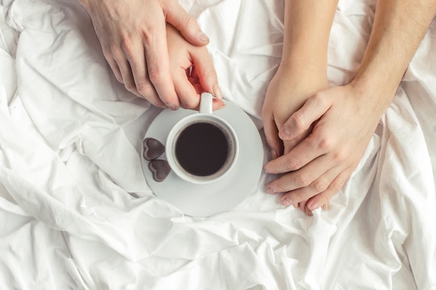 Coffee in bed. Selective focus. Love drink.