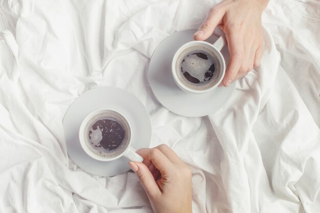 Coffee in bed. Selective focus. Love drink.