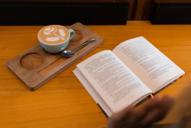 Coffee and book on the table for the morning routine of a young woman