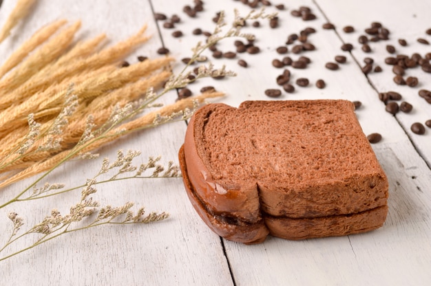 Coffee Bread and Coffee Bean for breakfast on wooden background