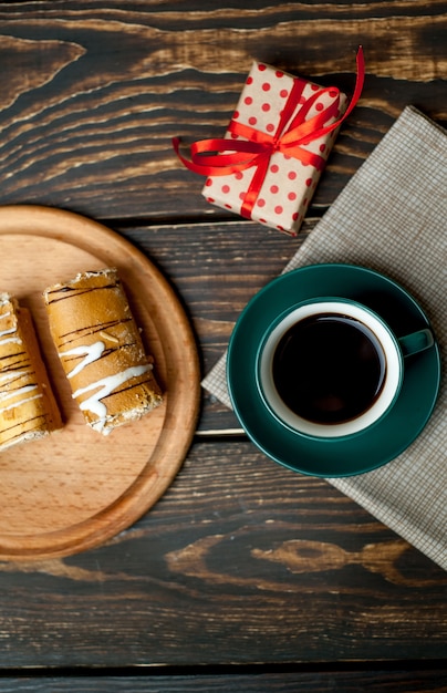 coffee and cake for breakfast on wood background