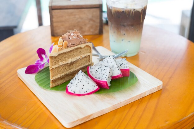 Coffee Cake topped with cream, chocolate and almonds, Milk Mint and top is coffee.