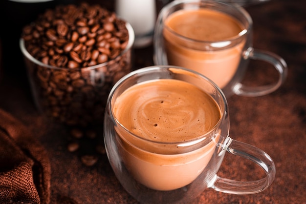 Coffee cappuccino in transparent cup on dark background. Hot coffee. High quality photo