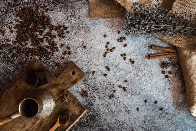 Coffee chocolate cinnamon lavender and spices on a brown wooden board