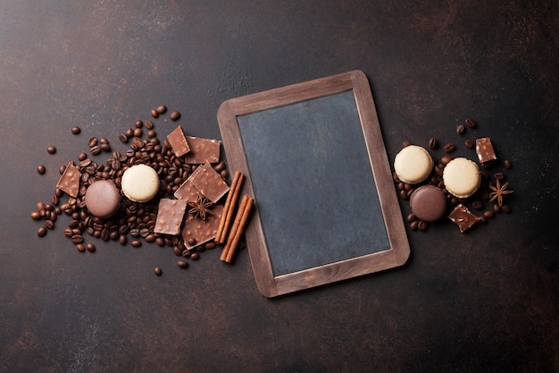 Coffee chocolate and macaroons on old kitchen table