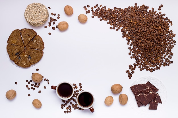 Coffee chocolate nuts and bread on a white background