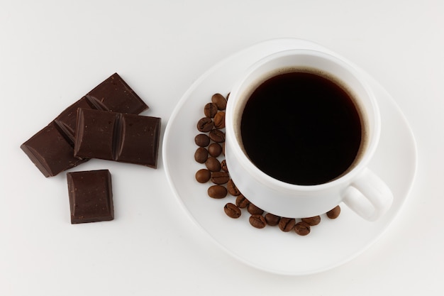 Coffee and chocolate on a white surface isolated