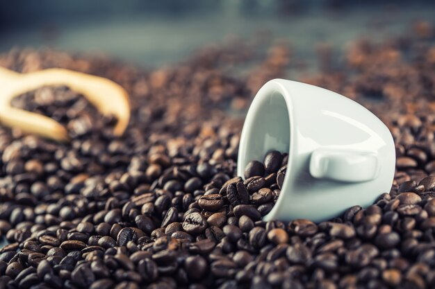 Coffee. Coffee beans. Coffee cup full of coffee beans. Toned image