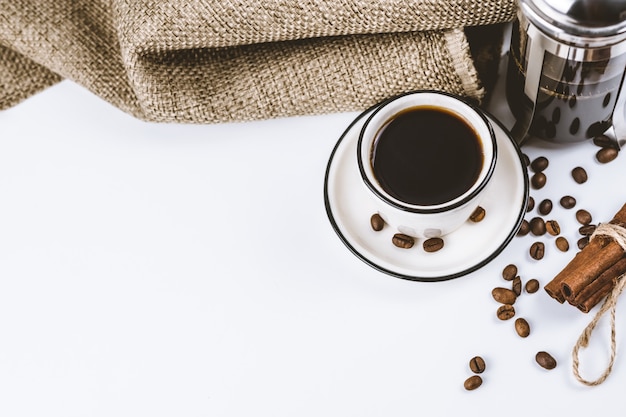 Coffee composition. French press and white handmade cup with coffee.