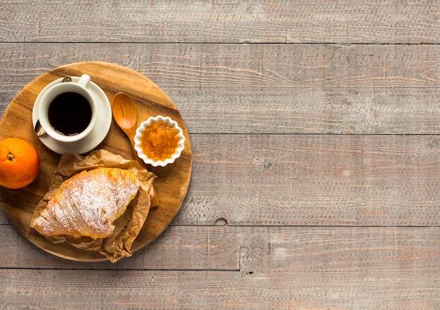 Coffee and croissant for breakfast, top view