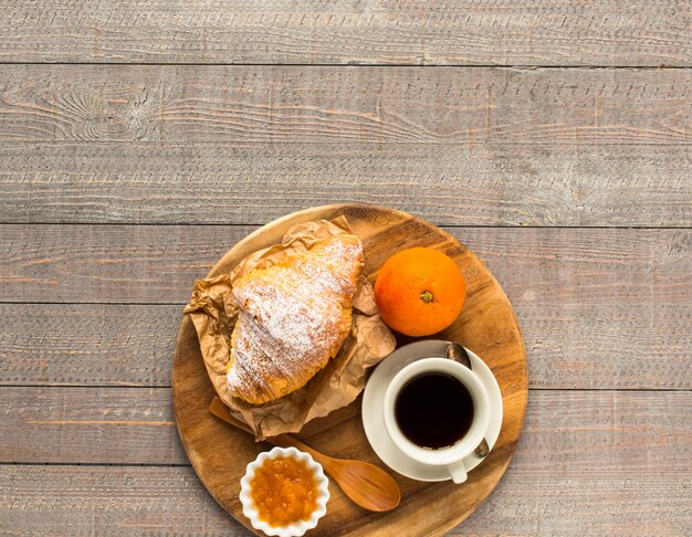 Coffee and croissant for breakfast, top view