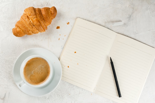 Coffee, croissants and notepad