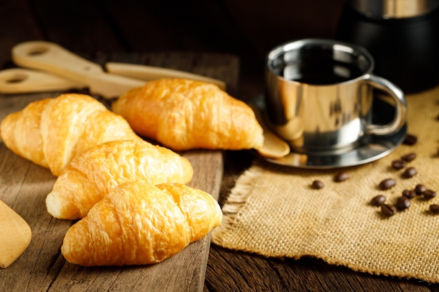 Coffee and croissants with burlap