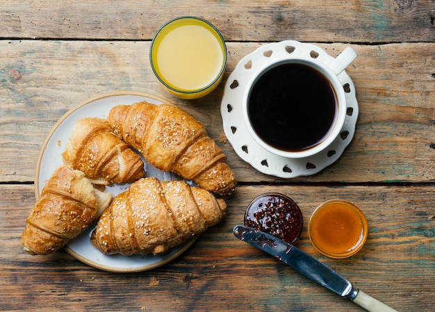 Coffee and croissants with jam and orange juice. Typical French Breakfast (Petit Déjeuner) 