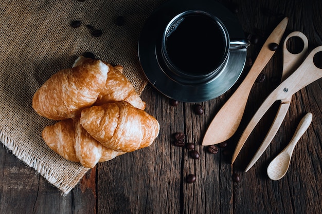 Coffee and croissants on the wooden