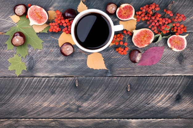 写真 コーヒーカップ、紅葉、木製の背景に乾燥ナナカマド