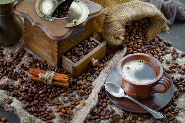 Coffee in a cup on a background of coffee beans on an old background