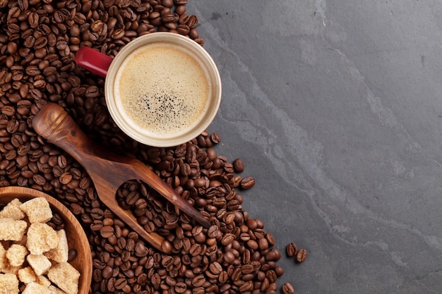 Coffee cup beans and brown sugar on stone table