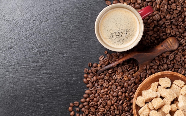 Coffee cup beans and brown sugar on stone table