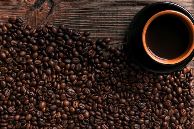 Coffee cup and beans frame on wooden table. top view. copy space. still life. mock-up. flat lay