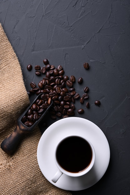 Coffee cup and beans on old grey kitchen beton , rock table. Top view with copyspace for your text