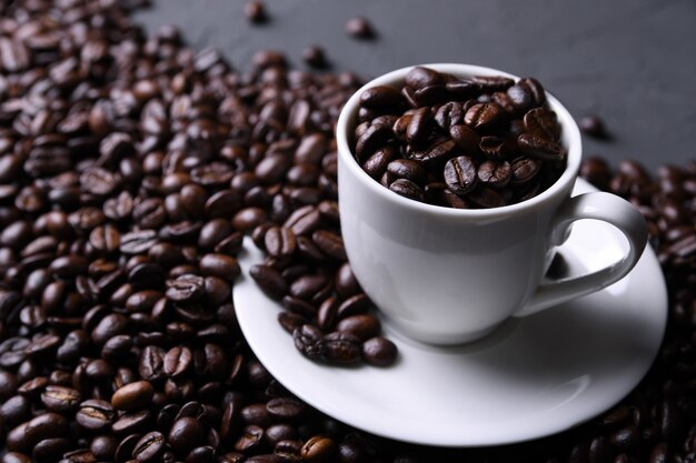 Coffee cup and beans on old grey kitchen beton , rock table. with copyspace for your text