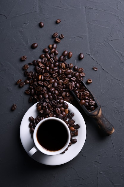 Coffee cup and beans on old grey kitchen beton , rock table. with copyspace for your text