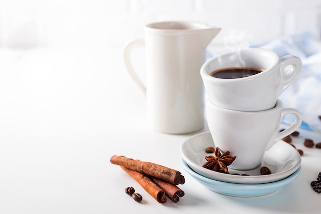 Tazza e fagioli di caffè su una priorità bassa bianca.