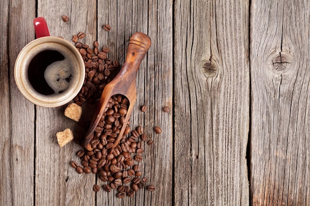 Coffee cup and beans on wooden table